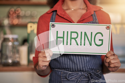 Image of Small business, hands or business owner with a hiring sign for job vacancy offer at a cafe or coffee shop. Recruitment, marketing or female entrepreneur standing with an onborading message in store