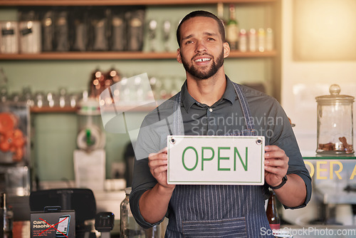 Image of Cafe, portrait or manager with open sign to welcome sales in a small business or coffee shop. Hospitality, restaurant or proud worker with a happy smile with message on board after opening a store