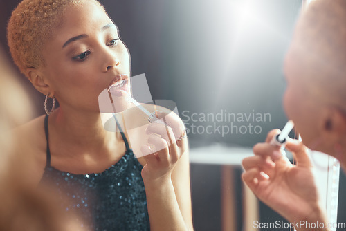 Image of Makeup, fancy and mirror reflection of a woman getting ready for a party, disco or event in a bathroom. Beauty, grooming and face of an elegant girl applying lipstick for a classy new year social