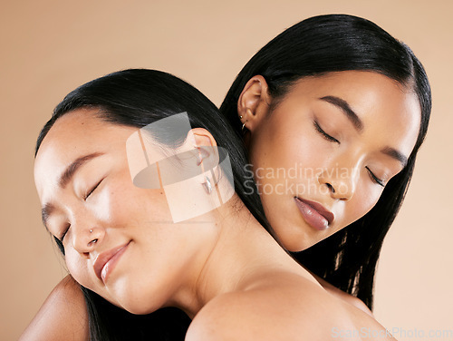 Image of Women, hug and skincare with cosmetics, dermatology and natural beauty on brown studio background. Females, ladies or makeup for confidence, embrace and wellness with support, happiness and soft skin