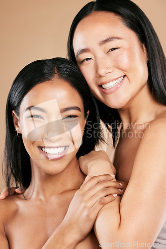 Image of Portrait, skincare and diversity with model woman friends in studio on a beige background for beauty. Face, skin and wellness with a young female and friend posing to promote a cosmetic product