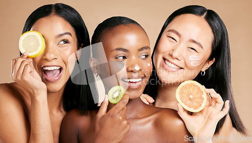 Image of Face, fruits and women in portrait with cream for facial care, beauty and natural cosmetics isolated on studio background. Sunscreen, vegan and different skin with skincare, moisturizer and playful