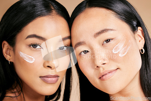 Image of Skincare, beauty cream and diversity women portrait in studio for dermatology, makeup and cosmetics. Asian and black person together for glow, spa facial and healthy face skin of friends for wellness