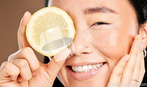 Image of Skincare, smile and portrait of a woman with a lemon for body detox, health and wellness. Vitamin c, food and happy Japanese model with a fruit for diet, nutrition and vegan beauty dermatology