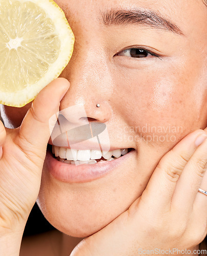 Image of Skincare, glow and portrait of a healthy woman with a lemon for body detox, health and wellness. Vitamin c, food and happy Japanese model with a fruit for diet, nutrition and vegan dermatology