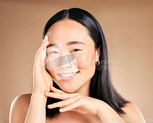 Image of Portrait, skincare and treatment with a model asian woman in studio on a beige background for natural beauty. Wellness, aesthetic or facial with an attractive young female posing to promote antiaging