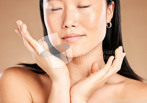 Image of Beauty, skincare or woman with hands by face in grooming routine isolated on studio background. Relaxing, Japanese or beautiful Asian girl model with eyes closed in facial treatment with self care