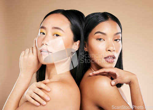 Image of Skincare, portrait and makeup for women in studio for wellness, hygiene and grooming on brown background. Face, friends and eyeshadow on girl with different, skin and beauty, relax and isolated