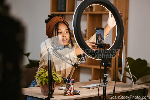 Image of Communication, phone and influencer live streaming podcast, radio talk show or speaker talk about teen culture. Presenter microphone, black woman setup broadcast or speaking about online student news