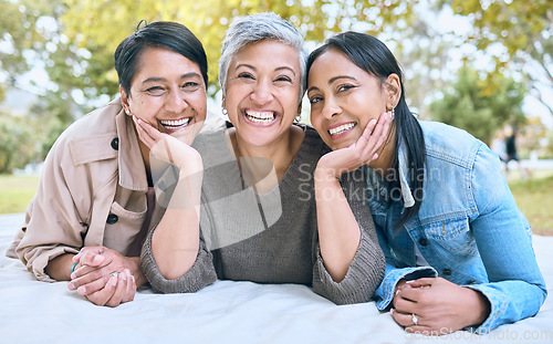 Image of Portrait, senior women and friends at park on picnic blanket, bonding and enjoying quality time together outdoors. Peace, retirement and happy group of elderly females embrace and relaxing in nature.