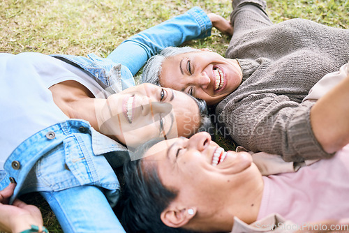 Image of Elderly, happy or friends on grass in a park talking or speaking of funny gossip relaxing holiday vacation in summer. Smile, old people or senior women laughing at a crazy joke or bonding in nature