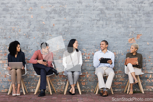 Image of Employee diversity, interview line and conversation with technology for meeting, recruitment or company hiring. Human resources, happy business people and discussion with laptop, tablet or smartphone