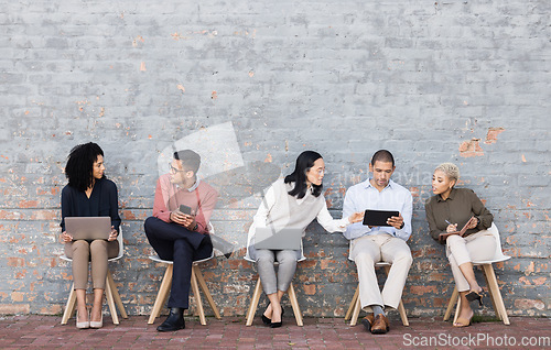 Image of Diversity, worker interview line and discussion with technology for meeting, recruitment or company hiring. Human resources, happy employees and speaking together on laptop, tablet or smartphone