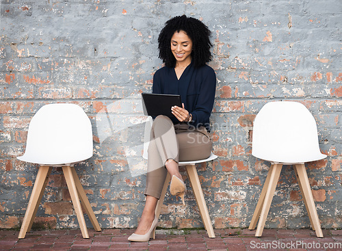 Image of Recruitment, tablet and woman sitting in line on brick wall for job opportunity, hr email and career networking. Digital technology, waiting room and black person on social media for we are hiring