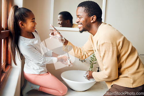 Image of Black family, washing hands and health care with soap to clean in home bathroom. Man teaching girl while cleaning body for safety, healthcare and bacteria for learning about wellness while bonding