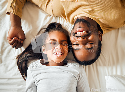 Image of Family, love and black man with girl or child lying in bed in a home smiling and bonding by having fun. Top, dad and daughter in a house with her father, face and happiness in a bedroom feeling happy