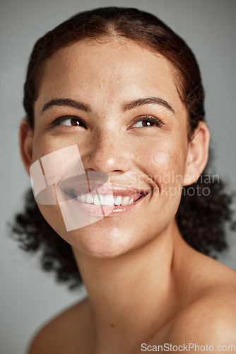 Image of Beauty, skincare and face of woman in studio isolated on a gray background. Makeup cosmetics, thinking and happy young female model with glowing, healthy and flawless skin after spa facial treatment