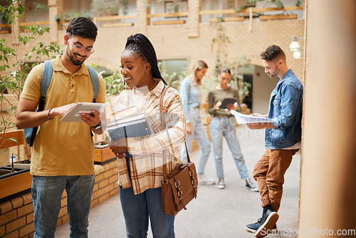 Image of Students, college and learning, tablet and books for education, scholarship and collaboration in campus hallway. University with people studying together, learn with diversity and academic goals