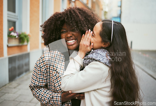 Image of Women, laughing or whispering secret in city street, road or urban London for gossip, story or news. Smile, happy or friends talking into ear in bonding travel with funny surprise, comic or meme joke