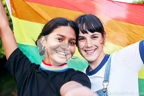 Image of Portrait, lesbian and couple with flag for pride, freedom and happy or bonding at festival. Face, lesbian couple and rainbow flag for human rights, lgbtq and liberation while standing, love and smile