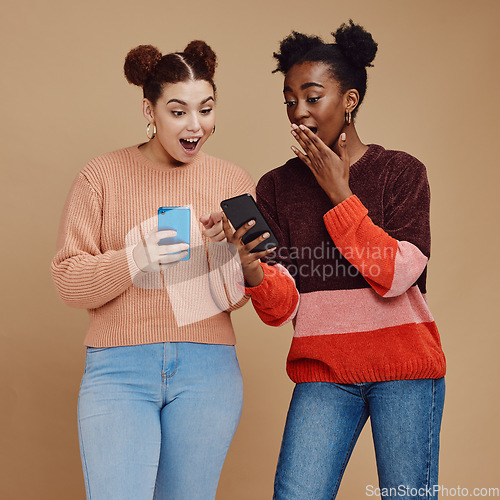 Image of News, wow and shocked people isolated on studio background for social media, gossip or trendy online sale. Smartphone, surprise notification and gen z friends, black woman reading announcement mockup