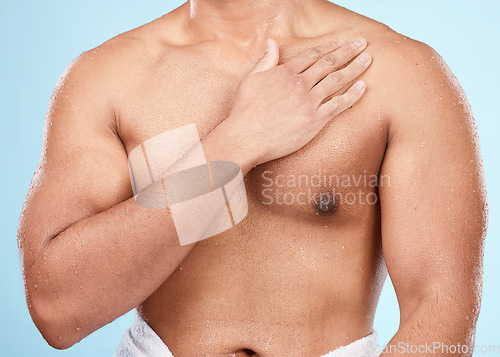 Image of Skin, body and man after skincare shower or bath for hygiene and wellness isolated against a blue background. Topless, clean and muscles of fit male doing self care cosmetic routine