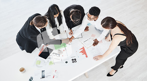 Image of Meeting, finance and teamwork with a business team working around a table in the boardroom from above. Accounting, documents and collaboration with a man and woman employee group at work in an office