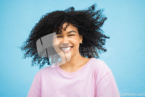 Image of Shake hair, face portrait and black woman with healthy shampoo hairstyle, studio beauty or luxury facial skincare. Cosmetic makeup, spa salon or afro girl from Brazil isolated on blue background wall
