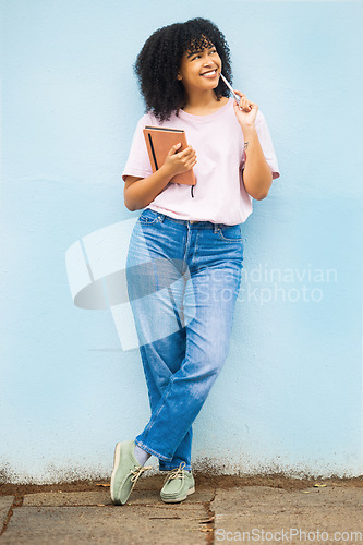 Image of Wall, black woman and writer thinking, creative decision and focus for ideas, notes and happiness. African American female, young person and student with pen, daydreaming and notebook for project