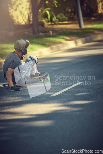 Image of Skateboard, street and mockup with a sports man skating or training outdoor while moving at speed for action. Fitness, exercise and road with a male skater or athlete outside to practice his balance
