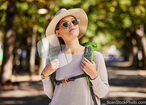 Image of Sunglasses, woman and travel in nature, adventure and tourist with smile, thinking and enjoy adventure. Female, tourism and lady with eyewear, road trip and walking for health, summer and happiness