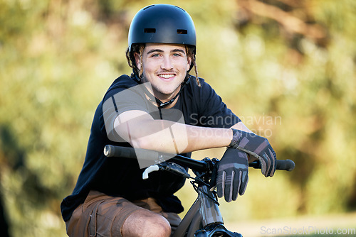 Image of Portrait, bike and fitness with a sports man taking a break outdoor in nature during his trail ride. Bicycle, exercise and workout with a male athlete training outside for cardio or endurance