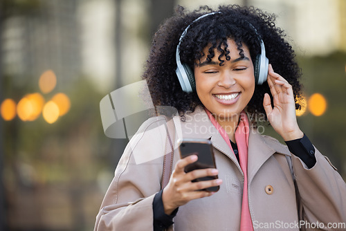 Image of Black woman, texting and phone in city with headphones, smile and social media chat. Gen z businesswoman, smartphone and online dating with music, podcast or digital networking app in metro