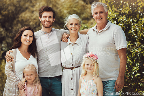 Image of Nature, happy and portrait of a big family in a garden while on a summer vacation together. Parents, grandparents and children on holiday, adventure or weekend trip at an outdoor park with happiness.