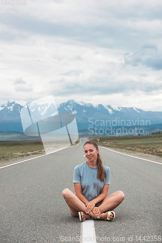 Image of Woman sitting on the road