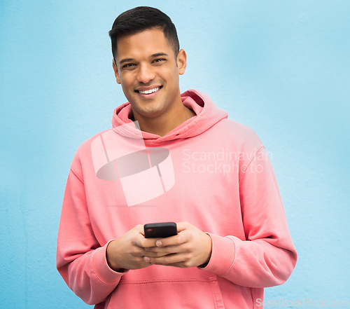 Image of Happy man, portrait or phone typing on isolated blue background on social media, fashion app or city internet. Smile, person or student model on mobile communication technology by Brazil wall mockup