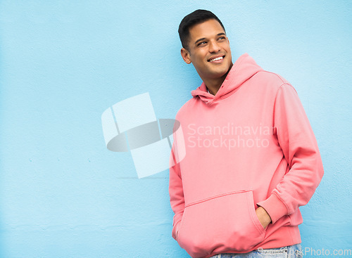 Image of Happy, casual and man in studio thinking, relax and normal against a blue background space. Laugh, contemplation and chilling Mexican man standing against mockup, real and cheerful while isolated