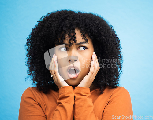 Image of Wow, surprise and thinking with a black woman in shock standing on a blue background in studio. Omg, confused and idea with an attractive young female looking shocked or surprised indoor