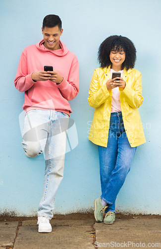 Image of Happy friends, bonding or phone typing on isolated blue background on social media, couple dating app or city networking. Smile, man or afro woman on mobile technology or community networking website