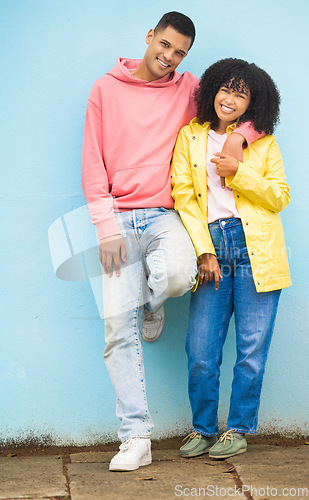 Image of Couple of friends, bonding or hug portrait on isolated blue background in fashion, afro hair trend or cool style clothes. Smile, happy man or black woman in embrace on mock up backdrop in Brazil city