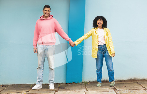 Image of Happy couple, love portrait and holding hands together for support care, relationship and bonding in urban town. Man, woman smile and partnership hand, romance and solidarity or compassion lifestyle