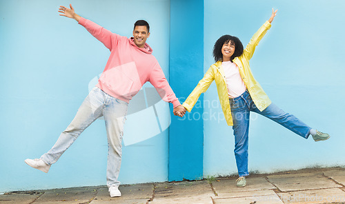 Image of Happy, smile and happy couple holding hands in the city street doing a silly, fun and goofy pose. Happiness, love and young man and woman with affection standing in a road in town on a walk in Mexico