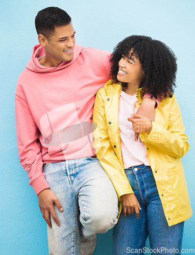 Image of Couple of friends, bonding and hug on isolated blue background in fashion, afro hair trend and cool style clothes. Smile, happy man and black woman in embrace on wall mock up backdrop in Brazil