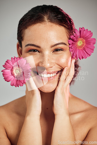 Image of Flowers, skincare and face portrait of a woman with natural beauty and a smile for dermatology. Facial, wellness and self care for skin glow, nature cosmetics or makeup of a healthy model in studio