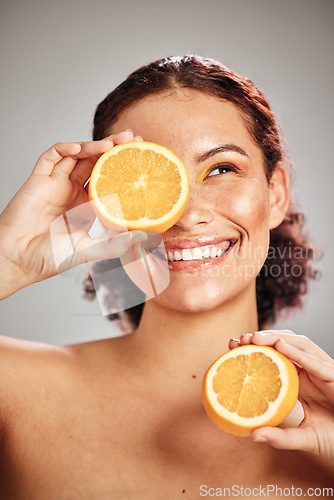 Image of Orange, beauty and woman face in studio with a smile for natural skin glow, cosmetic and dermatology. Facial results, health and wellness of aesthetic model person happy with vitamin c fruit idea