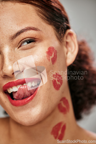 Image of Beauty woman, lipstick kiss and face of makeup model in studio for cosmetics, love and happiness. Headshot of aesthetic person lick teeth for valentines day spa facial idea or skincare motivation