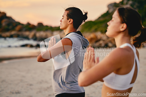 Image of Couple, prayer hands and yoga meditation at beach outdoors for health and wellness. Sunset, pilates fitness and man and woman with namaste hand pose for training, calm peace and mindfulness exercise