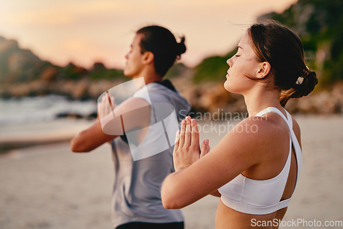 Image of Yoga couple, prayer hands and meditation at beach.outdoors for health and wellness. Sunset, pilates fitness and man and woman with namaste hand pose for training, calm peace and mindfulness exercise.