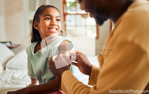 Image of Injury, father and arm bandage for girl after accident in bedroom. First aid, black family and man apply bandaid or plaster on wound of hurt or injured child for wellness, recovery and healthcare.