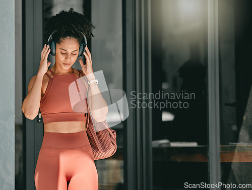 Image of Fitness, walking and black woman listen to music, relax podcast or radio for calm, stress relief or wellness mockup. Headphones, leaving gym and mock up girl on travel after training workout exercise